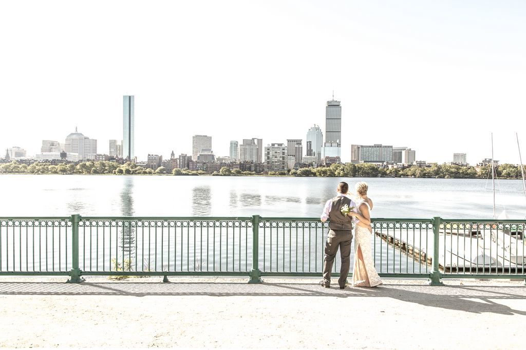 A bride and groom eloped in Boston this is their first time seeing the Charles river